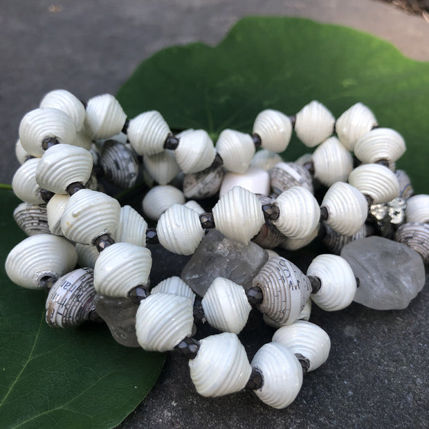 Make a statement with our one of a kind, Haitian Papillion Blanc beaded necklace. Hand strung with handmade beads individually rolled from a variety of recycled, printed paper and semi-precious gemstones.
