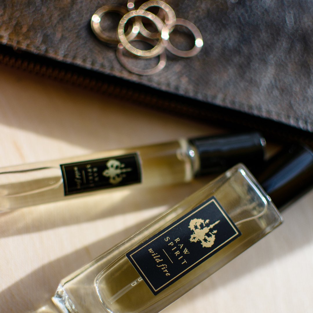 WILD FIRE Unisex Perfume Gift Set, Eau de Parfum Spray and Rollerball - a $125.00 value, yours for $95.00 (you save $30!)  A seductive dry, woodsy scent which blends premium wild-harvested Australian sandalwood with creamy amber and floral notes of ylang ylang, jasmine petals, cedarwood and musk.