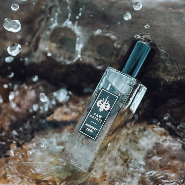 Raw Spirit Summer Rain unisex perfume is a refreshing citrus fragrance with kaffir lime and grapefruit with a burst of orangeflower and jasmine petals, anchored in a base of premium Haitian vetiver and cedarwood.